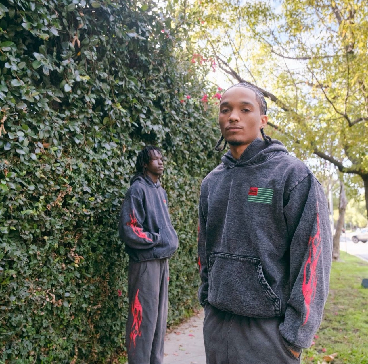 Raww Life model wearing a dark hoodie outdoors